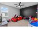 Unique bedroom features a car-shaped bed, ceiling fan, and ample space for play at 293 Pineywoods St, St Cloud, FL 34772