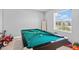 Recreational room with a pool table, window with blinds, and a tiled floor at 293 Pineywoods St, St Cloud, FL 34772