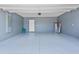 Spacious two-car garage with painted floor, ready for parking and storage at 293 Pineywoods St, St Cloud, FL 34772