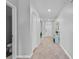 Neutral-toned hallway featuring tile flooring and access to various rooms with modern doors at 293 Pineywoods St, St Cloud, FL 34772