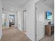 Hallway between multiple rooms on carpet at 293 Pineywoods St, St Cloud, FL 34772
