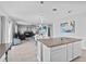 Open kitchen with modern lighting, island, and easy access to living area at 293 Pineywoods St, St Cloud, FL 34772