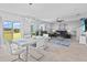 Open-concept living area with modern decor, tile floors, and sliding glass doors leading to the outdoors at 293 Pineywoods St, St Cloud, FL 34772