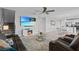 Spacious living room featuring a fireplace, ceiling fan, and open floor plan at 293 Pineywoods St, St Cloud, FL 34772