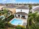 Aerial view of the backyard pool, patio, and lush landscaping of this home at 301 Pendant Ct, Kissimmee, FL 34747