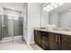 Modern bathroom featuring glass enclosed shower, granite counters, and vanity at 301 Pendant Ct, Kissimmee, FL 34747