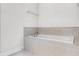 Elegant bathroom featuring a relaxing soaking tub with neutral tile surround at 301 Pendant Ct, Kissimmee, FL 34747