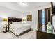 Inviting bedroom featuring plush bed, dark wood dresser, and decorative lamps at 301 Pendant Ct, Kissimmee, FL 34747