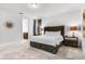 Spacious bedroom with soft carpet, plush headboard, and ensuite bathroom at 301 Pendant Ct, Kissimmee, FL 34747