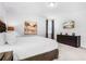 Comfortable bedroom with queen size bed, dark wood dresser, and large wall art at 301 Pendant Ct, Kissimmee, FL 34747