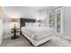 Bright bedroom with a tufted headboard, neutral decor, and lots of natural light at 301 Pendant Ct, Kissimmee, FL 34747