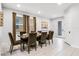 This dining room includes seating for six, a glass table, neutral paint and flooring, and natural lighting at 301 Pendant Ct, Kissimmee, FL 34747
