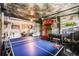 Unique game room featuring custom wall art, ping pong table, pool table, and foosball for Gathering entertainment at 301 Pendant Ct, Kissimmee, FL 34747