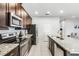 Modern kitchen features stainless steel appliances and a granite countertop island at 301 Pendant Ct, Kissimmee, FL 34747