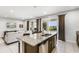 An open-concept kitchen and living room area has granite countertops and stainless steel appliances at 301 Pendant Ct, Kissimmee, FL 34747