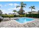 Inviting pool area features lounge chairs, lush landscaping, and a serene backyard setting at 301 Pendant Ct, Kissimmee, FL 34747