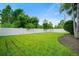Well-maintained backyard with lush green grass and a sturdy white fence for privacy at 3100 Stonewyck St, Orlando, FL 32824