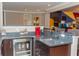 Stylish bar area with granite countertops, beverage cooler and comfortable seating at 3100 Stonewyck St, Orlando, FL 32824