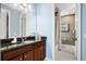 Charming bathroom featuring a shower-tub combo, granite-topped vanity, and a decorative mirror at 3100 Stonewyck St, Orlando, FL 32824