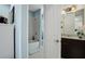 Well-lit bathroom features a shower-tub combo, tile flooring, and a granite-topped vanity with dark wood cabinets at 3100 Stonewyck St, Orlando, FL 32824