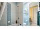 Stylish bathroom featuring tiled shower-tub combo and vanity with a blue accent wall at 3100 Stonewyck St, Orlando, FL 32824
