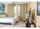 Bright bedroom with a white bed, geometric pendant light, and striped curtains at 3100 Stonewyck St, Orlando, FL 32824
