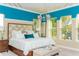 Serene main bedroom with tray ceilings, many windows, and a luxurious headboard at 3100 Stonewyck St, Orlando, FL 32824