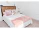 Cozy bedroom with a white bed, light pink blanket, and a wooden headboard at 3100 Stonewyck St, Orlando, FL 32824
