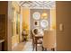 Elegant dining room featuring decorative mirrors, a modern chandelier, and natural light from the nearby window at 3100 Stonewyck St, Orlando, FL 32824