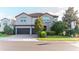 Charming two-story home with a three-car garage and brick-paved driveway at 3100 Stonewyck St, Orlando, FL 32824