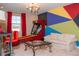 Exciting game room with vibrant colors, a fun skee-ball game, a modern coffee table and a cozy couch at 3100 Stonewyck St, Orlando, FL 32824