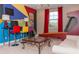 Exciting game room with vibrant colors, a fun skee-ball game, a modern coffee table and a cozy couch at 3100 Stonewyck St, Orlando, FL 32824