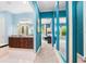 Hallway that connects different rooms, enhanced by blue accent walls and large mirrors that amplify the sense of space at 3100 Stonewyck St, Orlando, FL 32824