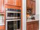 Beautiful kitchen with built-in stainless steel oven and wine rack above granite countertop at 3100 Stonewyck St, Orlando, FL 32824