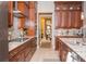 Gourmet kitchen with wood cabinets and stainless steel appliances leading to dining area at 3100 Stonewyck St, Orlando, FL 32824