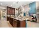 Open concept gourmet kitchen, with stainless steel dishwasher and granite countertop island at 3100 Stonewyck St, Orlando, FL 32824