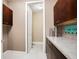 Convenient laundry room with cabinets, countertops, tile flooring, and modern decor at 3100 Stonewyck St, Orlando, FL 32824