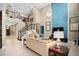 Bright living room features soaring ceilings, neutral tones, and staircase to upper level at 3100 Stonewyck St, Orlando, FL 32824