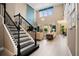 Open-concept living area with high ceilings, black staircase, and abundant natural light from large windows at 3100 Stonewyck St, Orlando, FL 32824