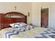 Comfortable bedroom with wooden headboard, neutral walls, and access to en-suite bathroom at 3112 Enclave Ct, Kissimmee, FL 34746