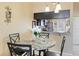 Cozy dining area featuring a modern granite table, stylish chairs, and convenient kitchen pass-through at 3112 Enclave Ct, Kissimmee, FL 34746