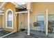 Charming townhouse entry featuring covered porch with decorative columns and seating at 3112 Enclave Ct, Kissimmee, FL 34746