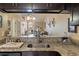 Kitchen pass-through with granite countertop overlooking the living area at 3112 Enclave Ct, Kissimmee, FL 34746
