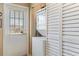 Practical laundry area with a stacked washer and dryer, louvered closet, and a convenient exterior access door at 3112 Enclave Ct, Kissimmee, FL 34746