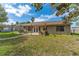 Spacious backyard boasts an outdoor patio with pergola, ideal for relaxing and entertaining at 3189 Saint James Ave, Deltona, FL 32738