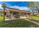 Enjoy outdoor dining on the patio with cafe lights, surrounded by a large yard at 3189 Saint James Ave, Deltona, FL 32738