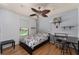 Bedroom featuring wood floors, a ceiling fan, and a view of the backyard at 3189 Saint James Ave, Deltona, FL 32738