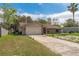 Charming single-story brick home featuring an attached two-car garage and well-maintained front yard at 3189 Saint James Ave, Deltona, FL 32738