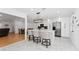 Bright open kitchen with white cabinetry, marble floors, stainless steel appliances, and a central island with seating at 3189 Saint James Ave, Deltona, FL 32738