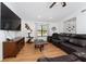 Comfortable living room with wood flooring, a large TV, and a plush leather sectional at 3189 Saint James Ave, Deltona, FL 32738